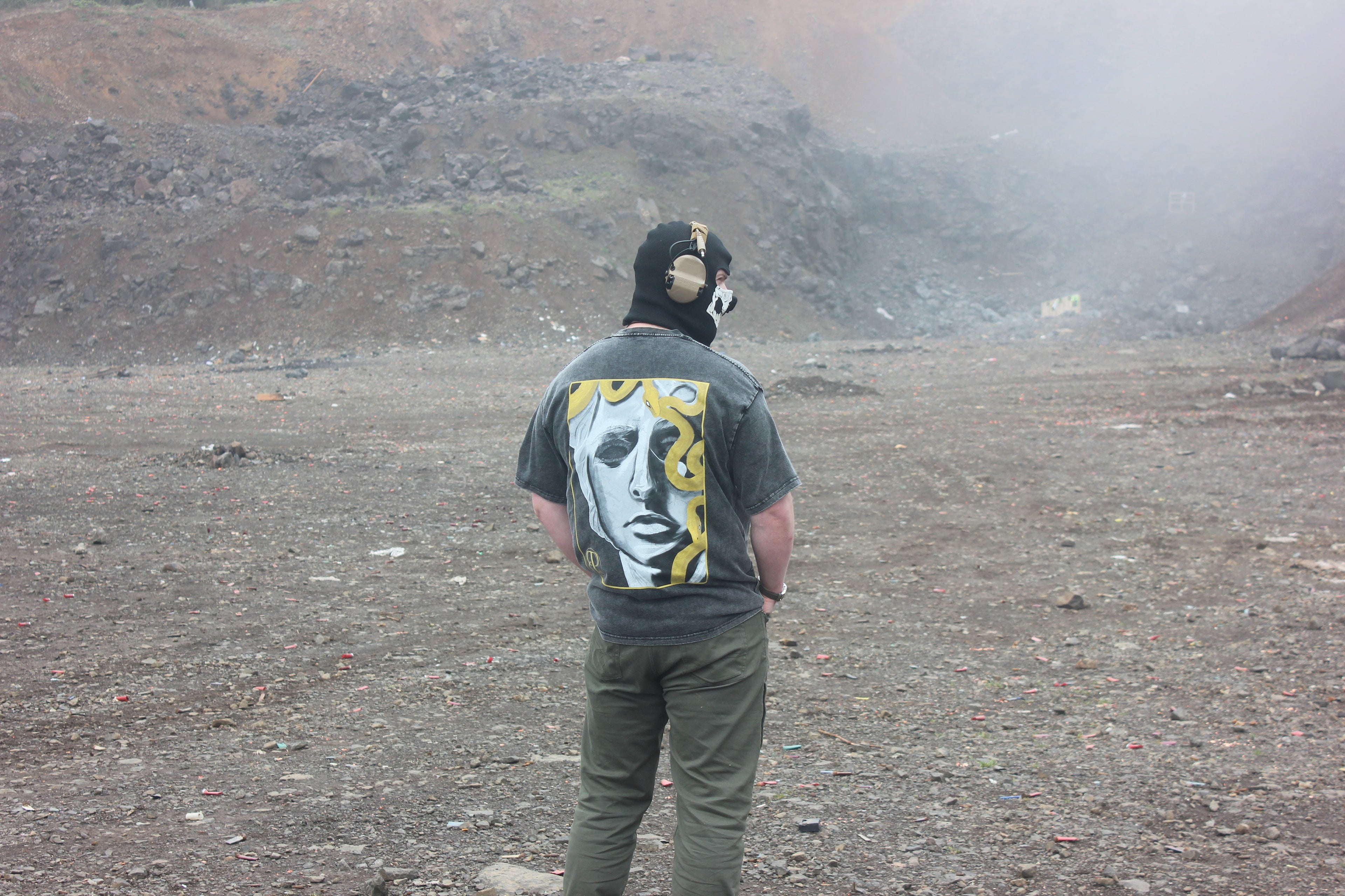 A figure with shirt with a design on it in a gravel pit